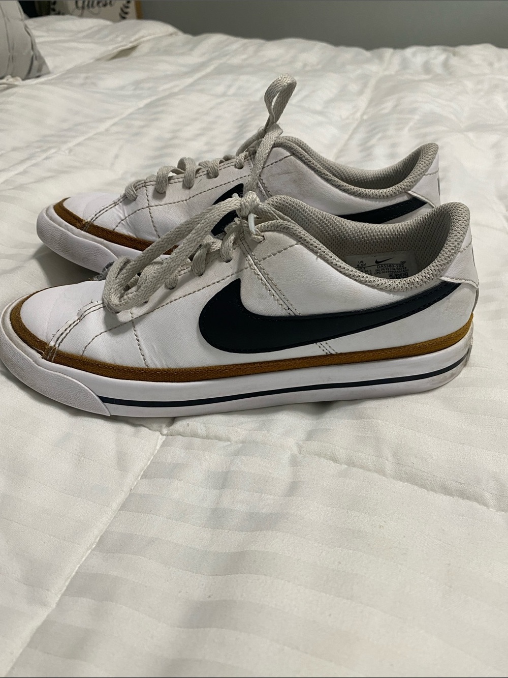 Nike White Low-Top Sneakers with Black Swoosh and Brown Trim